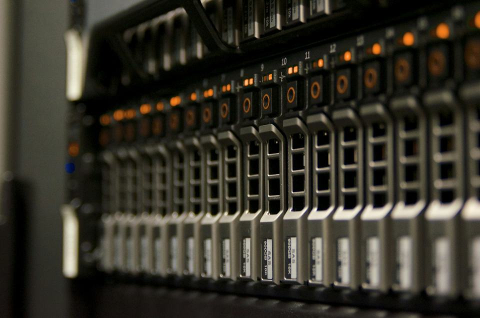 Rack of enterprise servers with amber status lights in a data centre