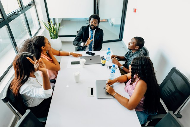 A team of professionals in discussion around a meeting table